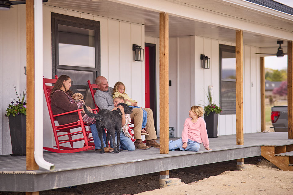 Rural 1st customers sit on front porch of construction project in western Colorado