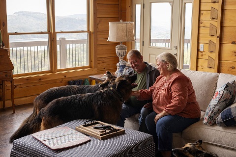 Farm owners interact with dogs in vacation second home financed by Rural 1st