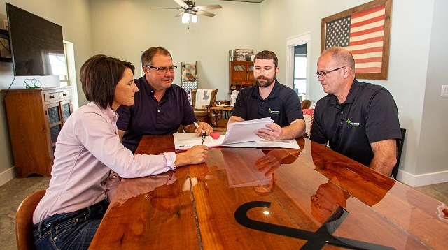 Couple reviewing paperwork with lenders.