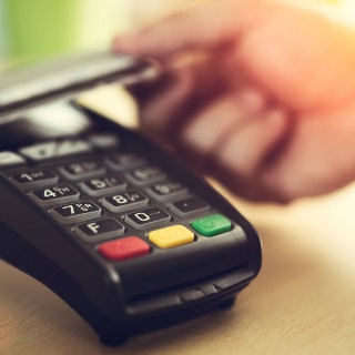 Farmer uses a credit card machine.