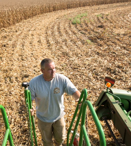 Man climbing into combine