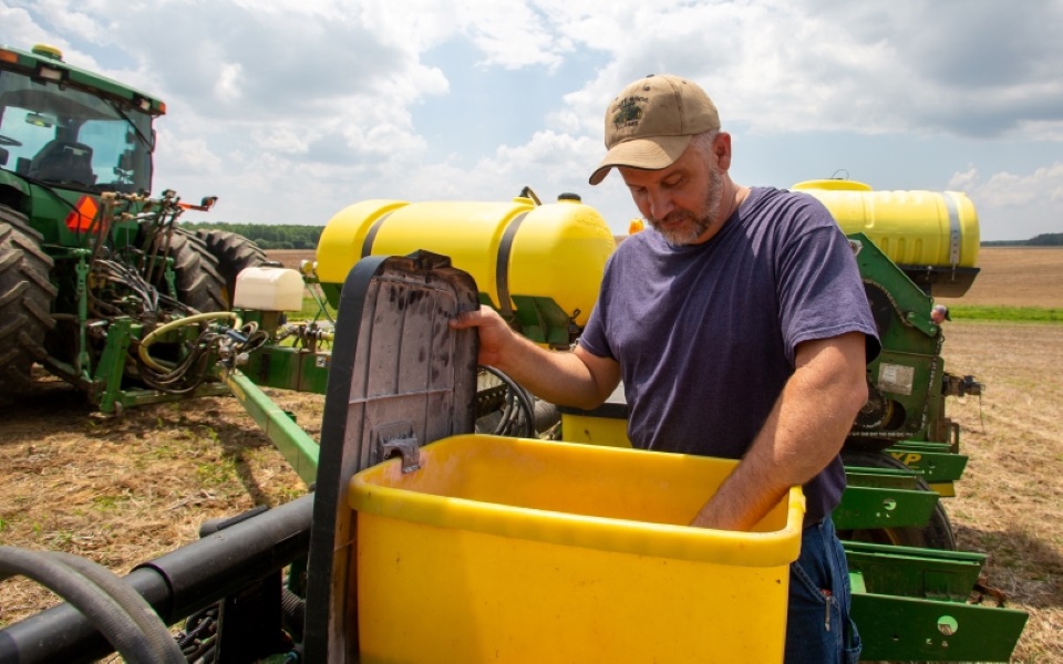 Farmer inspecting his planter.