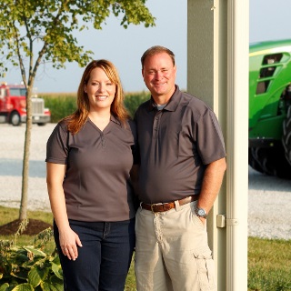 Couple standing under porch.