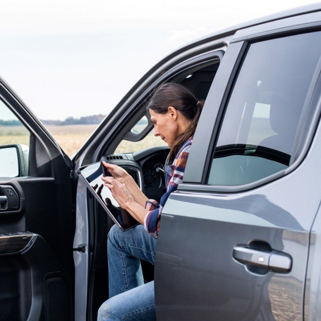 Woman using a tablet in a truck.